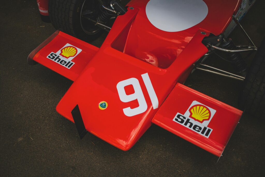 Detailed view of a red racing car's front section featuring Shell branding and number 91.