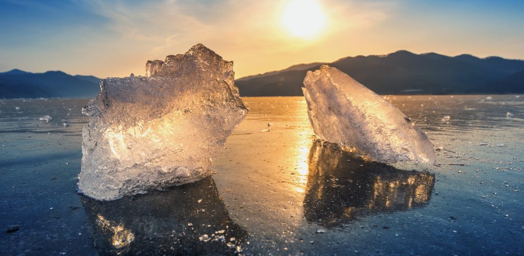 very large and beautiful chunk of ice at sunrise in winter.